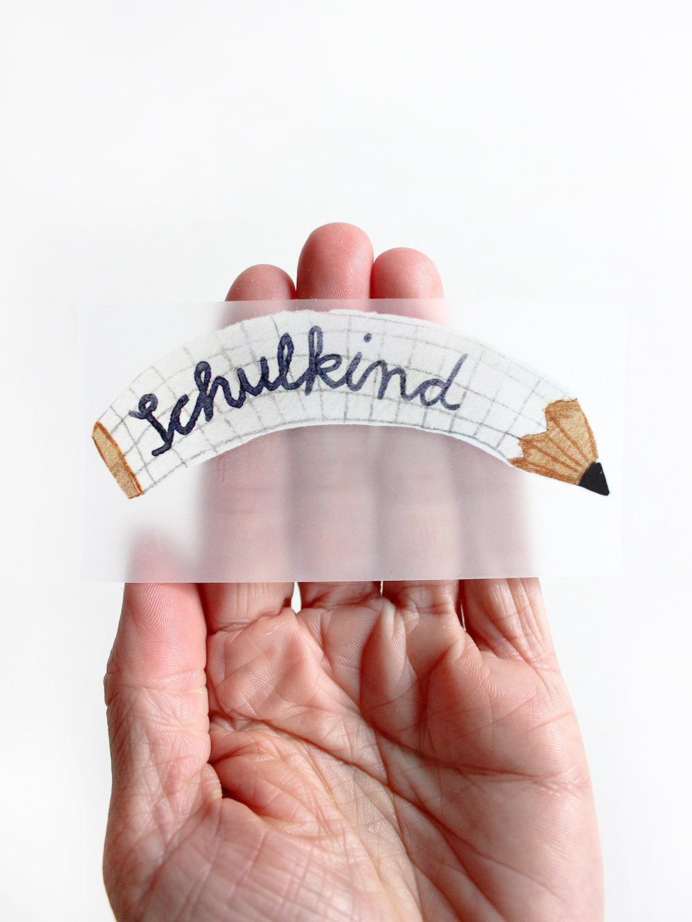 bügelbild randlos von stift mit schriftzug schulkind in hand gehalten