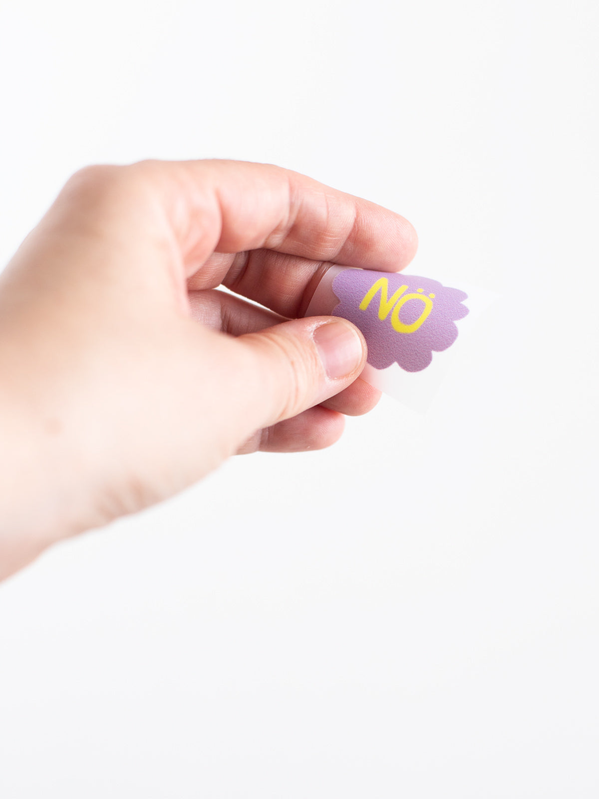 Hand mit dem kleinen Buegelbild aus dem Set Bügelbild randlos Nö in Flieder mit gelber Schrift von Halfbird