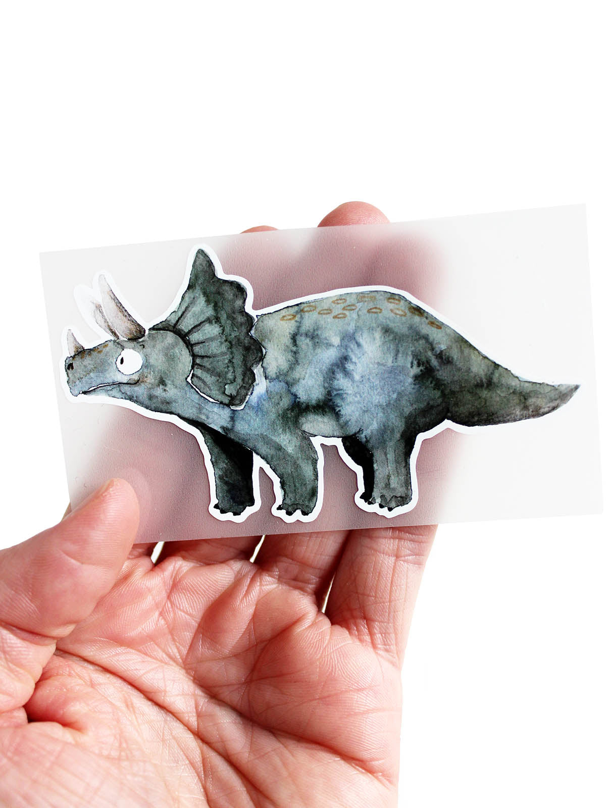Bügelbild Triceratops Dino auf der Hand