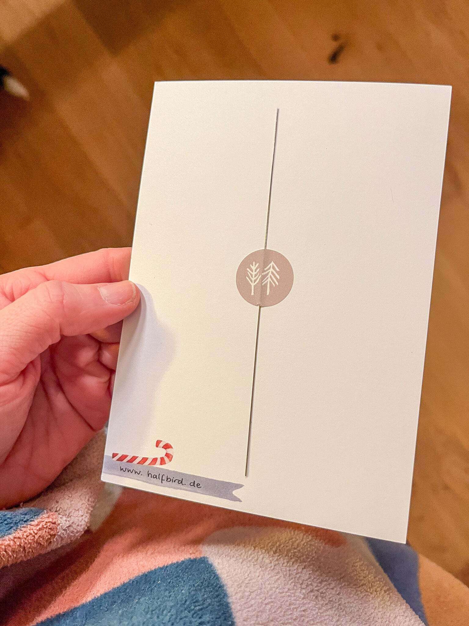 Auffädelhilfe von halfbird auf einer Karte geklebt