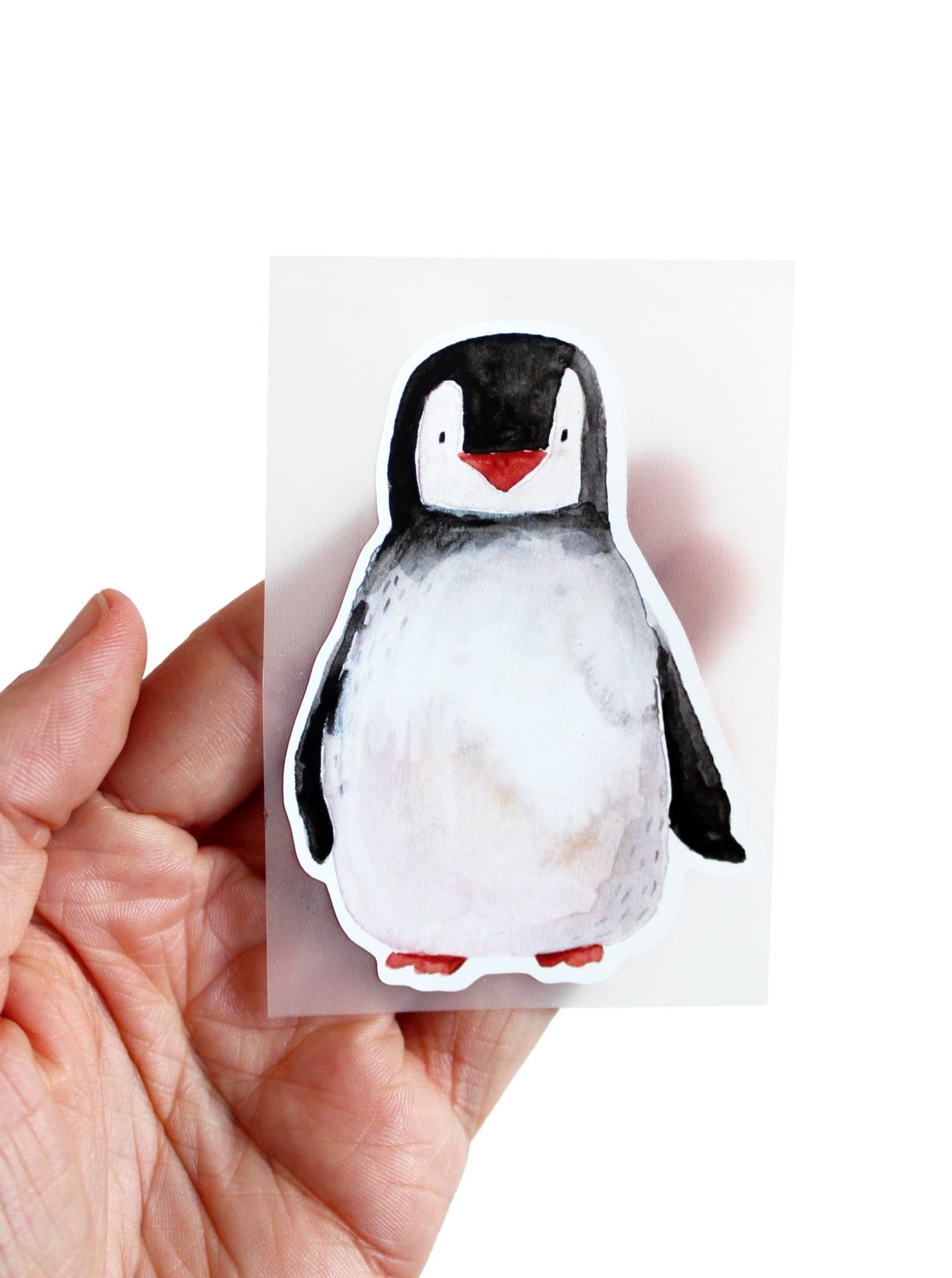 Bügelbild Pinguin in schwarz weiß auf der Hand liegend